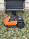Worx WR155 20V Cordless Robotic Mower - Black/orange. Fixed Price $550.00.
